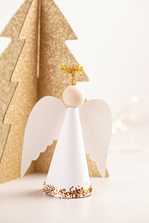 Christmas greeting card mock up with paper angel and christmas tree and decoration.の写真素材