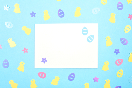 Empty card with spring, easter decoration over blue pastel backgroung with copy spaceの写真素材