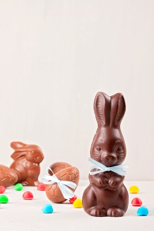 Easter composition with chocolate eggs and bunny on  wooden background, space for textの写真素材