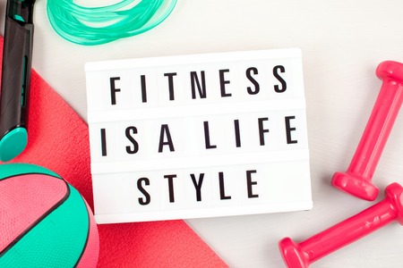 Flat lay of red dumbbell, sport equipments, fitness items, top view with copy space. Healthy lifestyle and weight loss conceptの写真素材