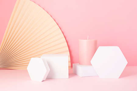 Podium, stand, platform for product presentation. Abstract background made of paper fans. Mockup for branding and packaging presentationの写真素材