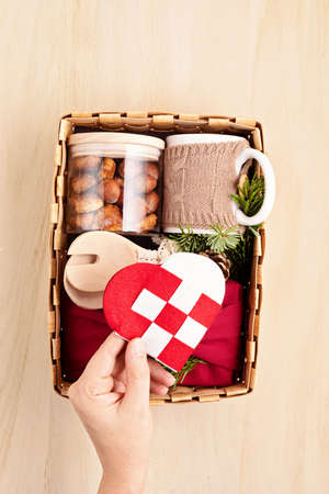 Preparing care package, sasonal gift box with kitchen utensils, furoshiki box and cookies....