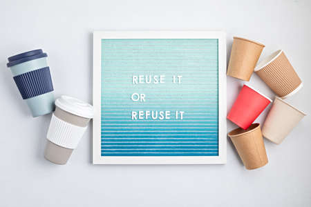 Reusable coffee cup and letterboard with text reuse it or refuse it. Zero waste sustainable lifestyle. Eco friendly habbits for take away coffeeの写真素材