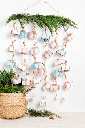 Handmade advent calendar. Gift boxes hanging on the rope. Eco friendly Christmas gifts diy conceptの写真素材
