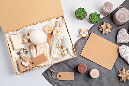 Preparing self care package, seasonal gift box with plastic free zero waste cosmetics products. Personalized eco friendly basket for family and friends for thankgiving, christmas, mothers dayの写真素材