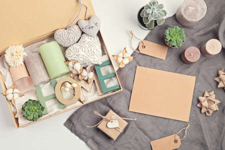 Preparing care package, seasonal gift box with candles, succulent, interior scent. Personalized eco friendly basket for family and friends for thankgiving, christmas, mothers day holidays.の写真素材