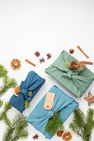 Furoshiki gifts. Eco friendly alternative green Xmas presents wrapped in clothes. Japanise tradition. Zero waste Christmas, flat lay, top viewの写真素材