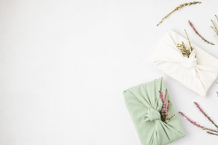 Zero waste gift wrapping traditional Japanese furoshiki style. Plastic free hand made gift package for Christmas, birthday, Easter and other occasionsの写真素材