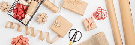 Eco friendly alternative green Xmas gifts wrapped with recycled craft paper. Zero waste Christmas,...