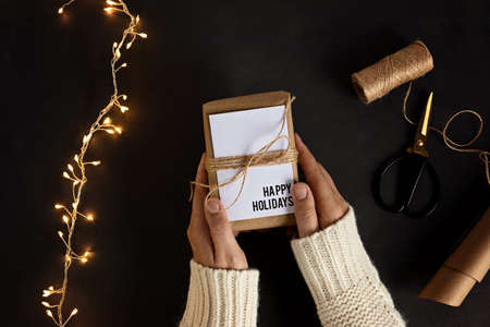 Eco friendly alternative green Xmas gifts wrapped with recycled craft paper. Zero waste Christmas;...