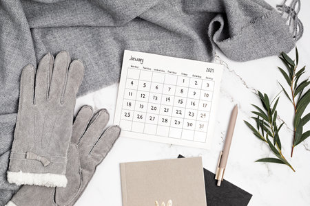 Desktop with calendar for january 2021 and office supplies. home office, social media blog, schedule, planning conceptの写真素材