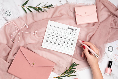 Desktop with calendar for january 2021 and office supplies. home office, social media blog, schedule, planning conceptの写真素材