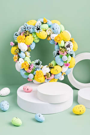 Podium, stand for product presentation and easter wreath with eggs. Mockup