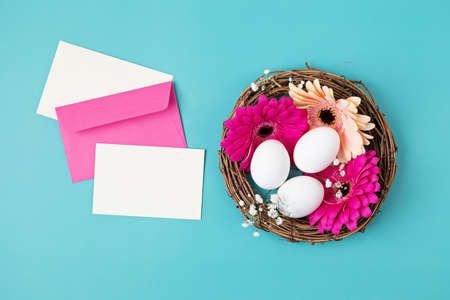 Handmade diy home interior decoration wreath with easter eggs over blue backgroundの写真素材