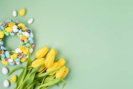 Handmade diy home interior decoration wreath with colorful easter eggs and tulips