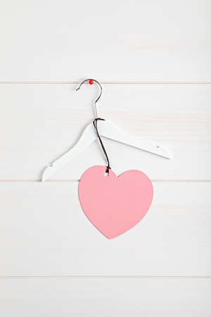 White rack with heart tag. Slow fashion concept mockupの写真素材