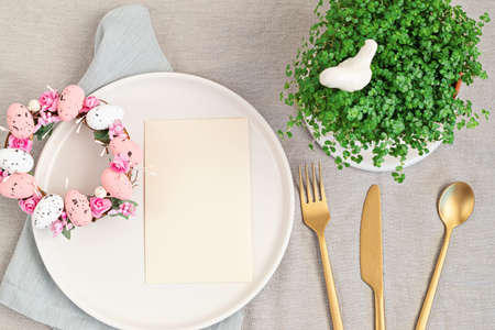 Flat lay with mockup menu and easter decoration. Easter wreath and blank card