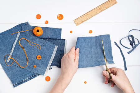 Old jeans upcycling idea. Crafting with denim, recycling old clothers, hobby, diy activityの写真素材