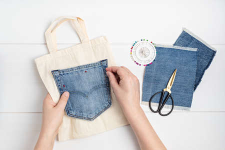 Old jeans upcycling idea. Crafting with denim, recycling old clothers, hobby, diy activityの写真素材