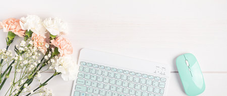 Home office desktop banner. Modern workspace with office stationary and flowersの写真素材