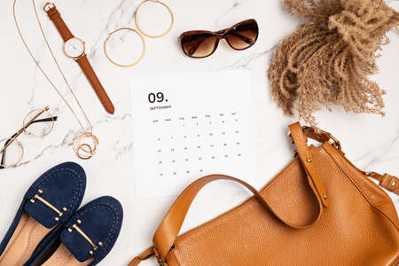 Flat lay with calendar for September with woman fashion fall accessoriesの写真素材