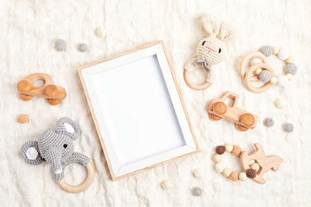 Eco fiendly child wooden toys and empty frame. Sustainable, developmental, sensory toys for babies and toddlers. Top view, flat layの写真素材