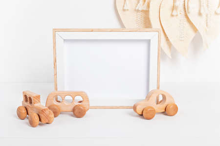 Eco fiendly child wooden toys and mockup frame in baby room interiorの写真素材