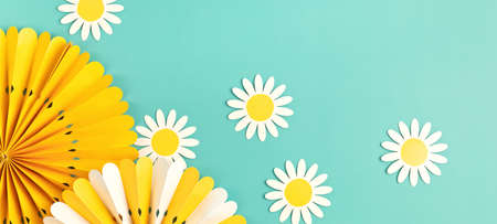 Festive party background with yellow paper circle fans over blue pastel backgroundの写真素材