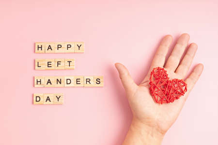 Text happy left handers day written with wooden letters and heart