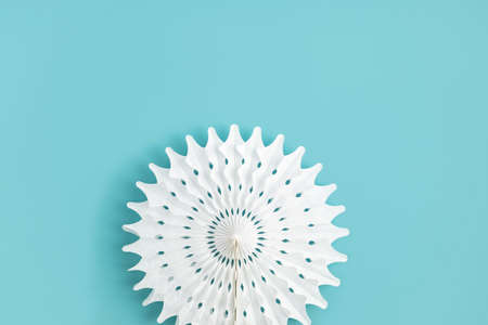 Festive party background with white paper circle fans over blue pastel backdropの写真素材
