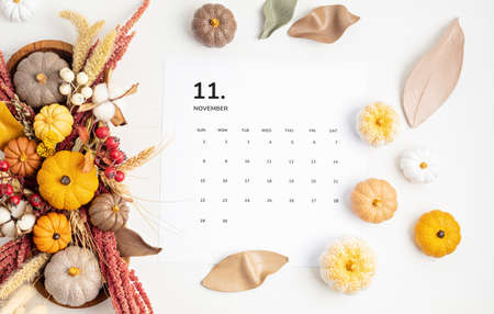 Flat lay with calendar for november with autumn table decorationの写真素材