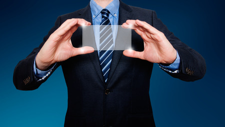 Touch screen concept - businessman - Blue background - Stock Imageの写真素材