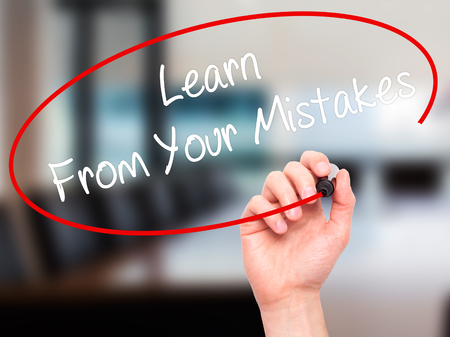 Man Hand writing Learn From Your Mistakes  with black marker on visual screen. Isolated on office. Business, technology, internet concept. Stock Photoの写真素材