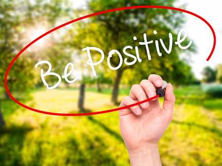 Man Hand writing Be Positive  with black marker on visual screen. Isolated on nature. Business, technology, internet concept. Stock Photoの写真素材
