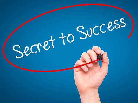Man Hand writing Secret to Success with black marker on visual screen. Isolated on blue. Business, technology, internet concept. Stock Photoの写真素材