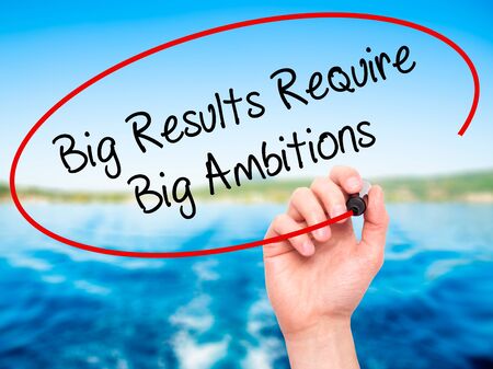 Man Hand writing Big Results Require Big Ambitions with black marker on visual screen. Isolated on nature. Business, technology, internet concept. Stock Photoの写真素材
