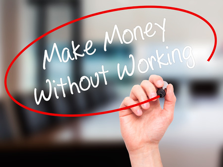 Man Hand writing Make Money Without Working with black marker on visual screen. Isolated on office. Business, technology, internet concept. Stock Photoの写真素材