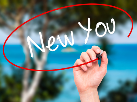 Man Hand writing New You with black marker on visual screen. Isolated on nature. Business, technology, internet concept. Stock Photoの写真素材