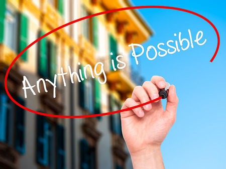Man Hand writing Anything is Possible with black marker on visual screen. Isolated on city. Business, technology, internet concept. Stock Photoの写真素材