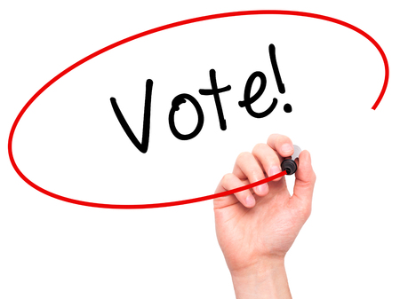 Man Hand writing Vote! with black marker on visual screen. Isolated on white. Business, technology, internet concept. Stock Photoの写真素材