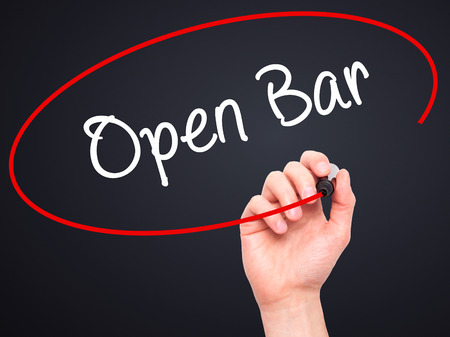 Man Hand writing Open Bar with black marker on visual screen. Isolated on black. Business, technology, internet concept. Stock Photoの写真素材