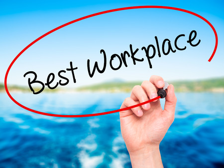 Man Hand writing Best Workplace with black marker on visual screen. Isolated on nature. Business, technology, internet concept. Stock Photoの写真素材