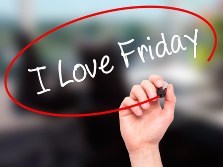 Man Hand writing I Love Friday with black marker on visual screen. Isolated on office. Business, technology, internet concept. Stock Photoの写真素材