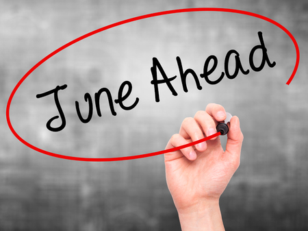 Man Hand writing June Ahead with black marker on visual screen. Isolated on grey. Business, technology, internet concept. Stock Photoの写真素材