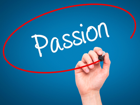 Man Hand writing Passion with black marker on visual screen. Isolated on blue. Business, technology, internet concept. Stock Photoの写真素材