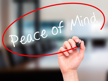 Man Hand writing Peace of Mind black marker on visual screen. Isolated on office. Business, technology, internet concept. Stock Imageの写真素材