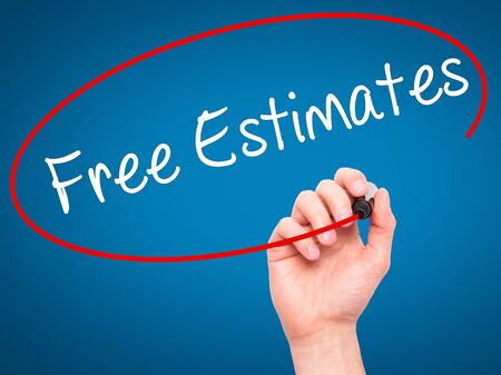 Man Hand writing Free Estimates with black marker on visual screen. Isolated on blue. Business, technology, internet concept. Stock Photoの写真素材