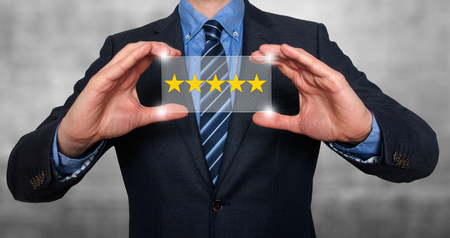 Businessman holding five star rating. Grey - Stock Imageの写真素材
