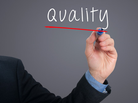 Businessman hand writing quality in the air. Greyの写真素材