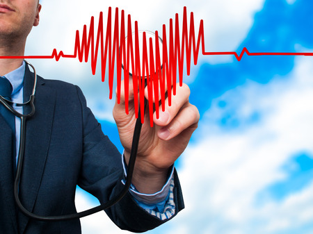 Closeup portrait handsome business man, male corporate employee, worker listening to  heart with stethoscope isolated on sky background. Preventive medicine, financial condition check-up conceptの写真素材